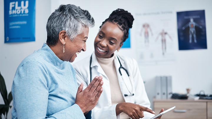 A doctor gives good news to a patient.